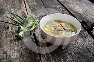 Pink bowl of creamed broccoli soup