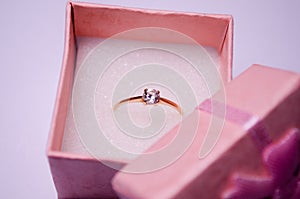 Pink box with a ring. Golden ring with a stone. Pink jewelry box. Ring for a gift. Bijouterie. Jewelry for girls. Jewelry