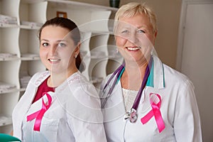 Pink breast cancer awareness ribbon against portrait of smiling