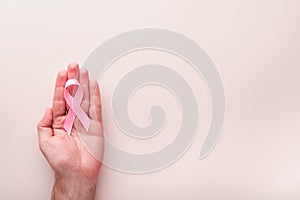 Pink Breast Cancer Awareness Ribbon. Hands holding pink ribbon on backgrounds. Breast cancer awareness and October Pink day, world