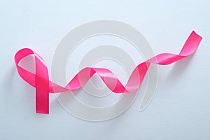 Pink breast cancer ribbon on blue background. Breast cancer awareness month concept