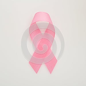 Pink breast cancer ribbon on white