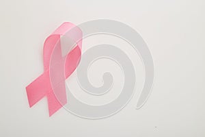 Pink breast cancer ribbon on white