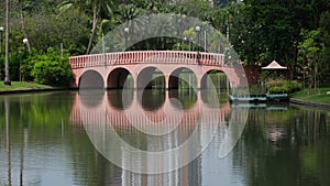 Pink bridge reflects in lake