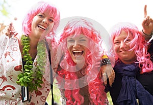 The pink brigade has arrived. Three friends having fun at a festival.