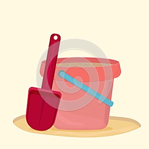 Pink bucket with sand and red shovel isolated