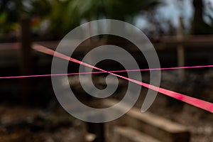 Pink builders string-line closeup on constructions site in selective focus