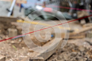 Pink builders string-line closeup on constructions site in selective focus