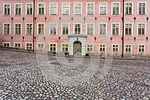 Pink building and cobblestoned road photo