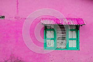 Pink building exterior, vintage wall with closed window and wo