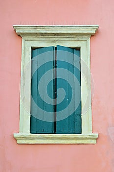 Pink building with window and green shutters, Verona Italy