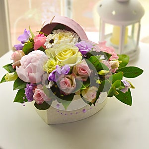 Pink buquet of gentle flowers in a box