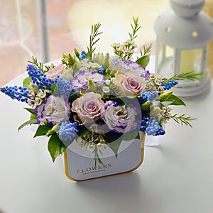 Pink buquet of gentle flowers in a hat box