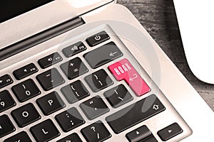 Pink button with word Hoax and arrow on laptop keyboard, closeup
