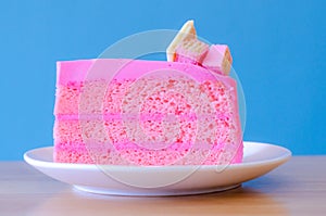 Pink cake on blue background,select focus.