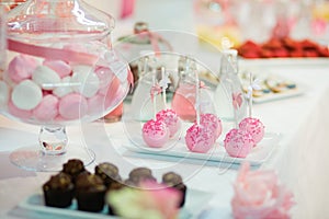 Pink cake pops on a dessert table