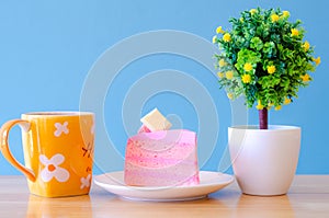 Pink cake and tea cup on blue background,break time,select focus.