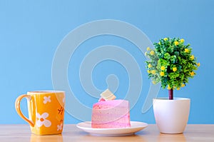 Pink cake and  tea cup on blue background,break time,select focus.