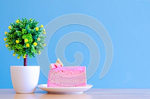 Pink cake and tea cup on blue background,break time,select focus.