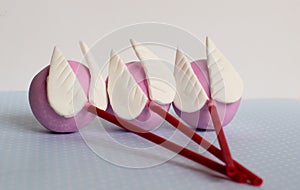 Pink cakepops with wings, blue background