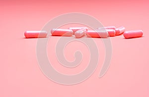 Pink capsule pills on pink background. Valentine's day concept. Pills of love. Happy Valentine's da