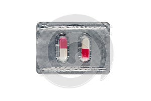 Pink capsules in a blister pack isolated on white