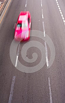 Pink car running on the road