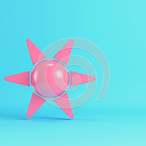 Pink cartoon style sun with rays on bright blue background in pastel colors