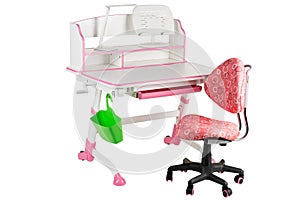 Pink chair, pink school desk, green basket and desk lamp