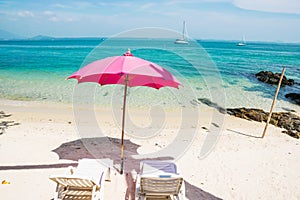 Pink chairs and pink umbrellas on the beach at Samed Island, Thailand