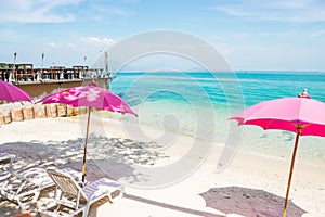 Pink chairs and pink umbrellas on the beach at Samed Island, Thailand