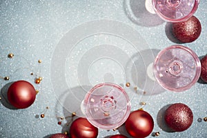 Pink champagne in crystal glasses on shiny mint blur background. New year celebration party with girly glam drink. Nightclub party