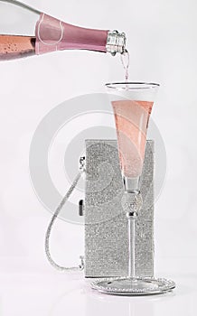 Pink Champagne Pouring into Silver Jeweled Glass