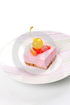 Pink cheesecake with maraschino cherry