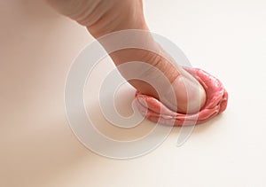 Pink chewing gum and man hand on white background