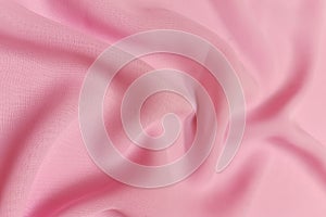 Pink chiffon fabric crumpled or wavy fabric texture background. Abstract linen cloth soft waves. Silk yarn. Smooth
