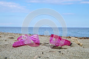 Pink children shoe on the beach.Selective focus