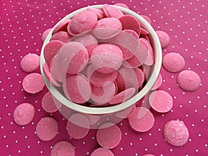 Pink Chocolate Candy Melts on pink polka dots Background