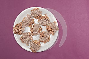 Pink chocolate covering peanuts as cluster