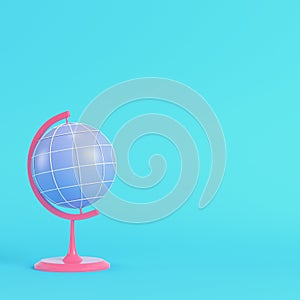 Pink chool globe on bright blue background in pastel colors