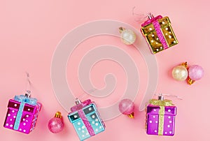 Pink Christmas background with balloons and gift box with copy space