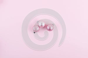 pink christmas balls on pink paper background