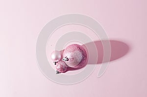 pink christmas balls on pink paper background
