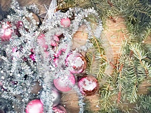 Pink Christmas decor on a wooden surface.