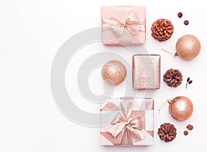 Pink christmas gifts isolated on white background. Wrapped xmas boxes, christmas ornaments, baubles and pine cones.
