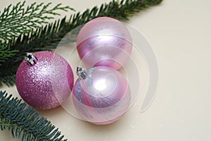 Pink Christmas Tree Glass Balls and and Fir Branches on Ivory Background with Copy Space