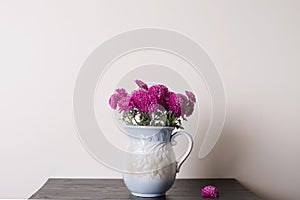 Pink chrysanthemum in a clay rarity vase