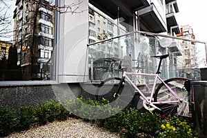 Pink city trek bicycle parked near building