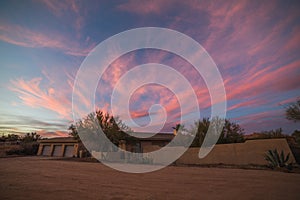 Pink Clouds and Blue Sky Over a Desert Home