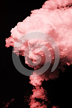 Pink clouds like a candy in a black background as an abstraction